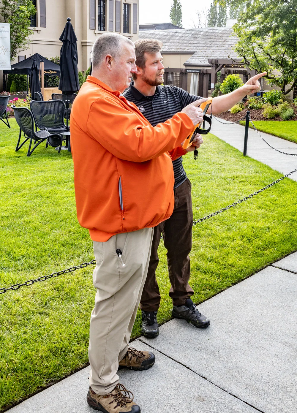 Men discussing outdoors.