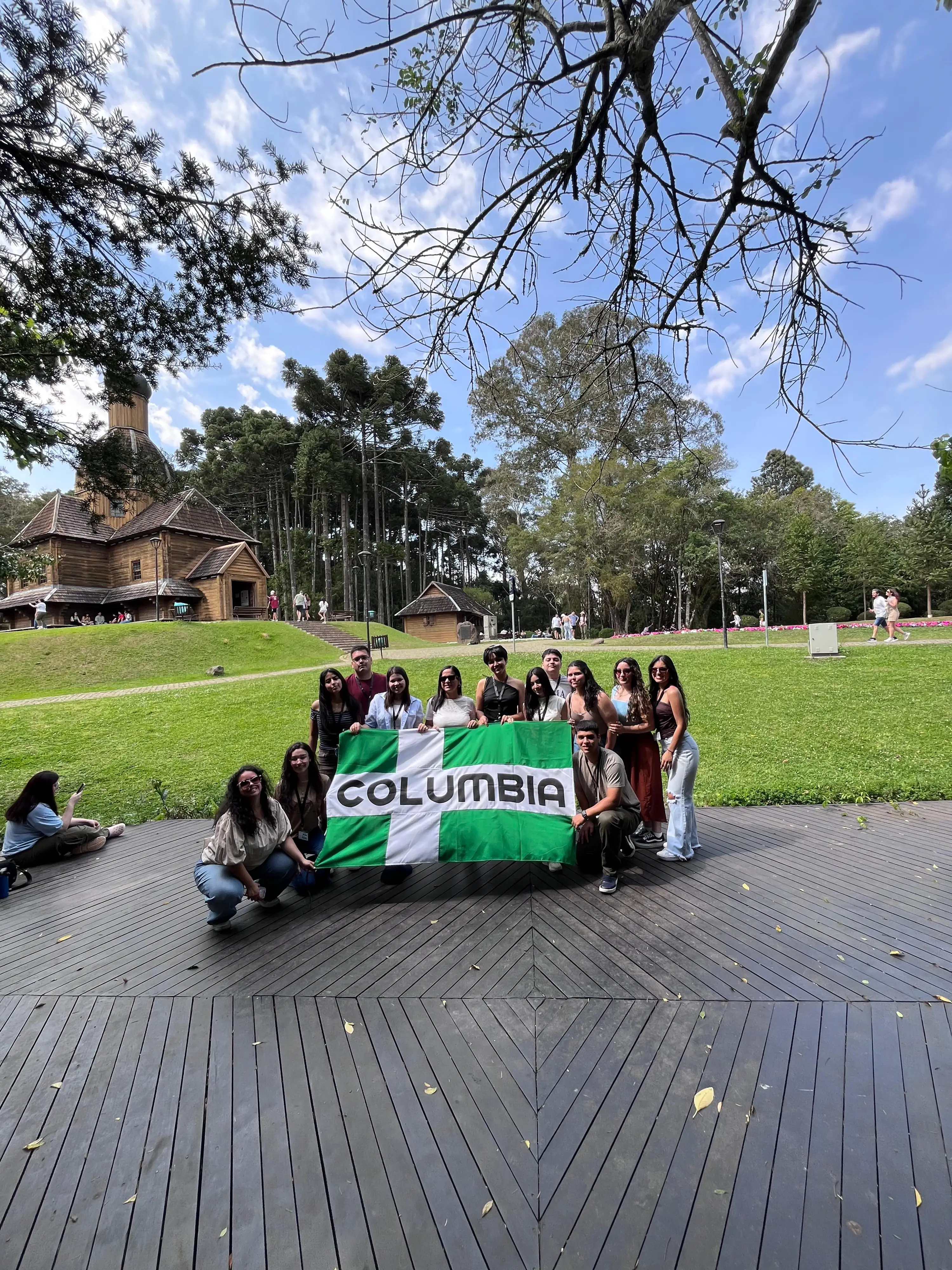 Group of people holding a green and white flag with 