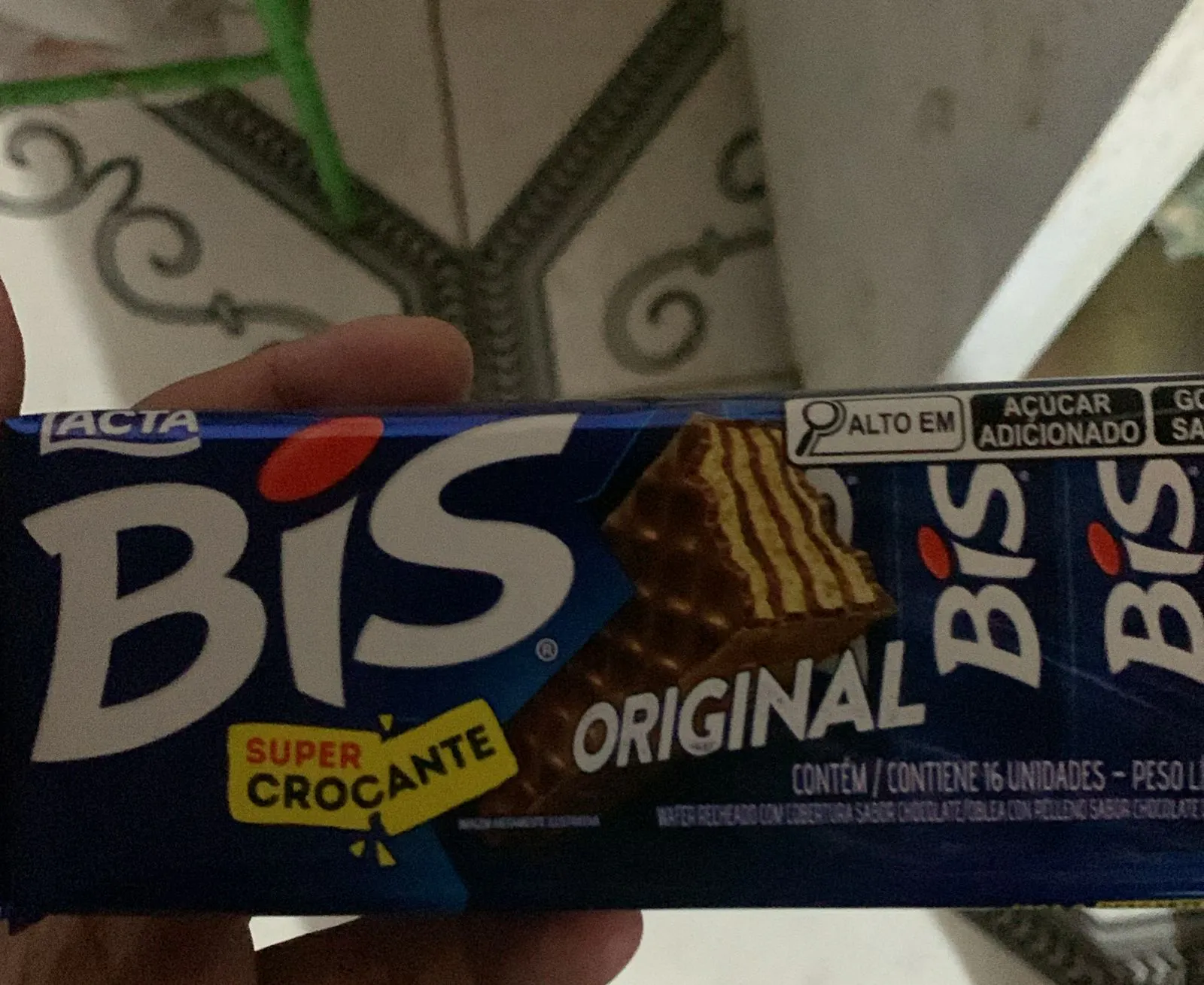 A hand holds a package of 